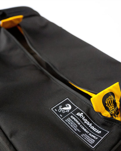 Woven Scraphouse label and zippered ventilation panel on the duffle's ballistic nylon shell