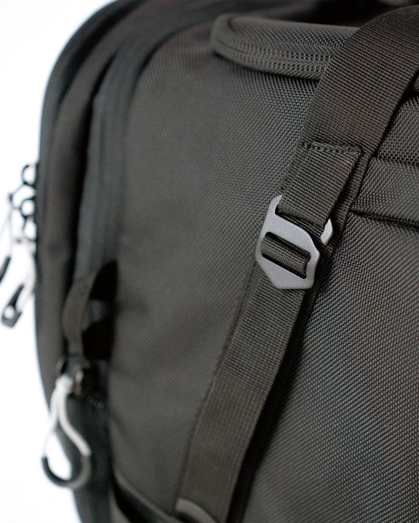 Close-up of 1680D ballistic nylon weave and metal strap hardware on the Scuffle Duffle