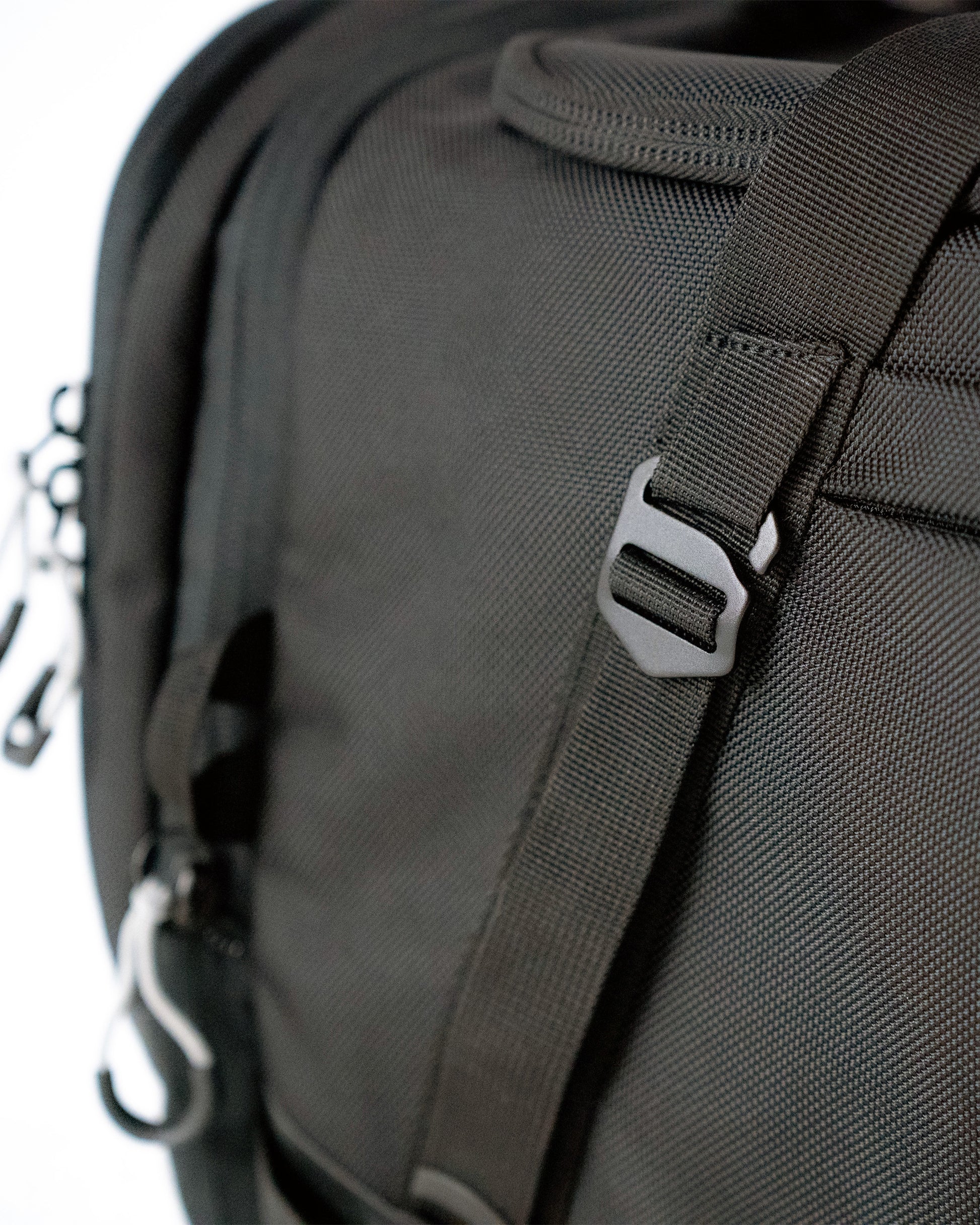 Close-up of 1680D ballistic nylon weave and metal strap hardware on the Scuffle Duffle