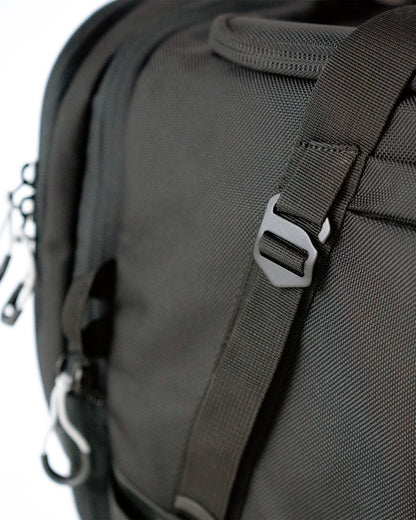 Close-up of 1680D ballistic nylon weave and metal strap hardware on the Scuffle Duffle