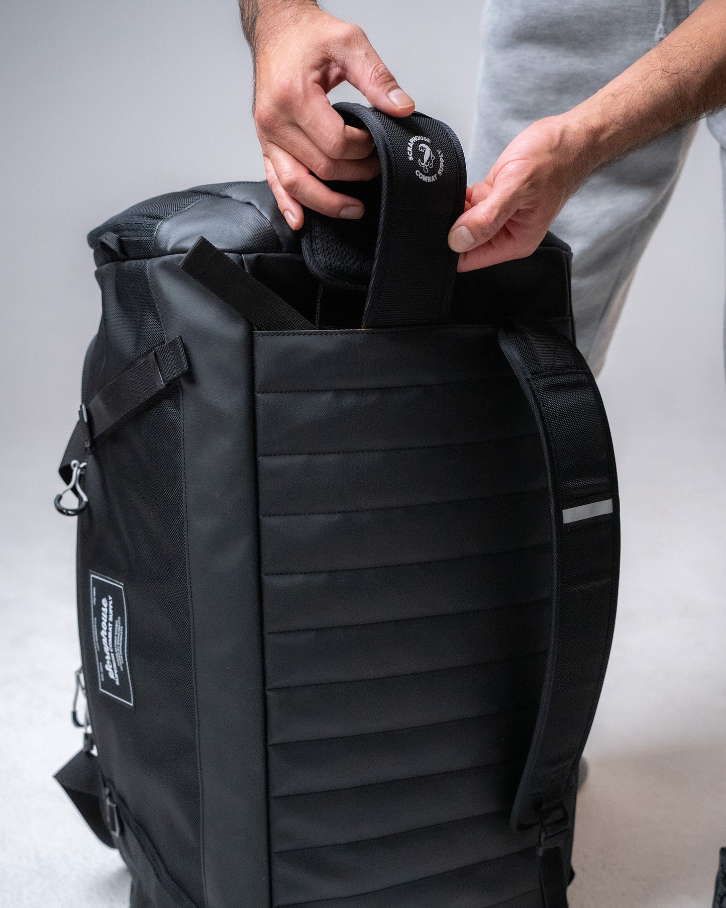 Deploying the stowaway backpack straps from the Scuffle Duffle's padded back panel