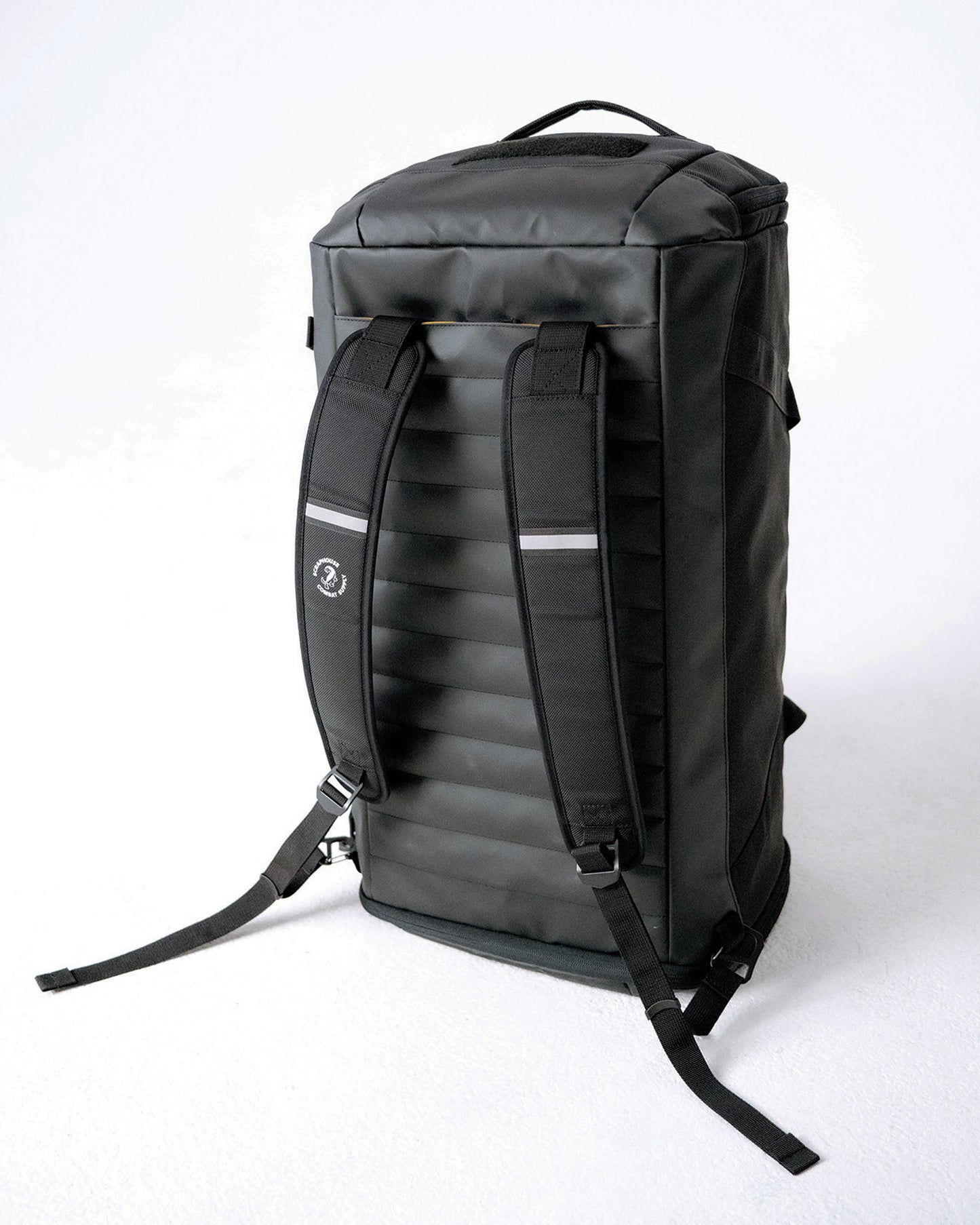 Rear view of the Scuffle Duffle in backpack mode with padded straps and reflective detailing