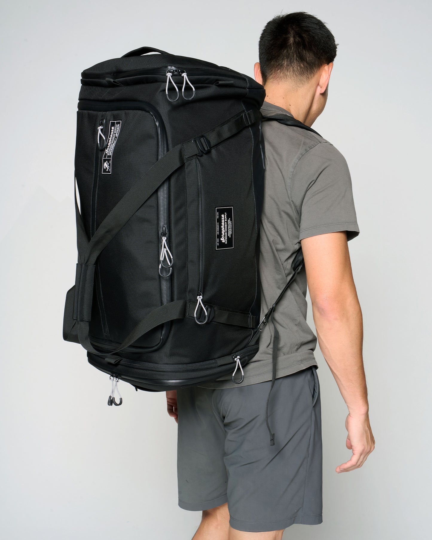 Athlete wearing the Scuffle Duffle in backpack mode with the stowaway straps deployed