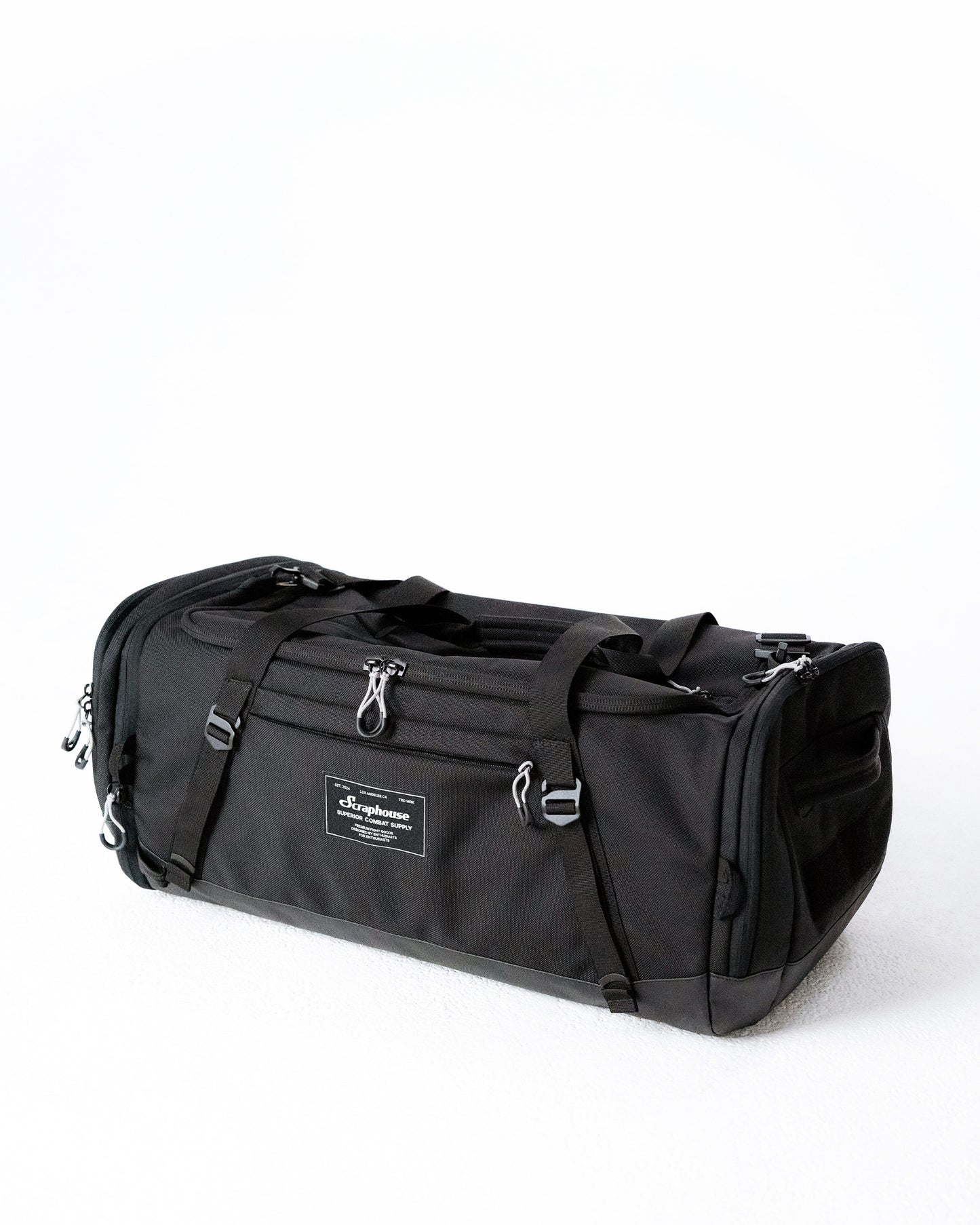 Scuffle Duffle combat sports gym bag in Volcanic Black, angled view showing the semi-rigid structure