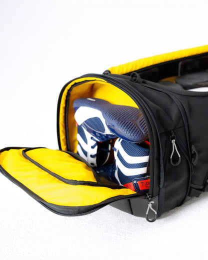 Expanding shoe compartment on the end of the Scuffle Duffle holding a pair of training shoes