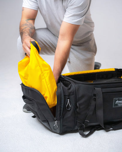 Pulling the included yellow wet bag from the Scuffle Duffle's dedicated side compartment