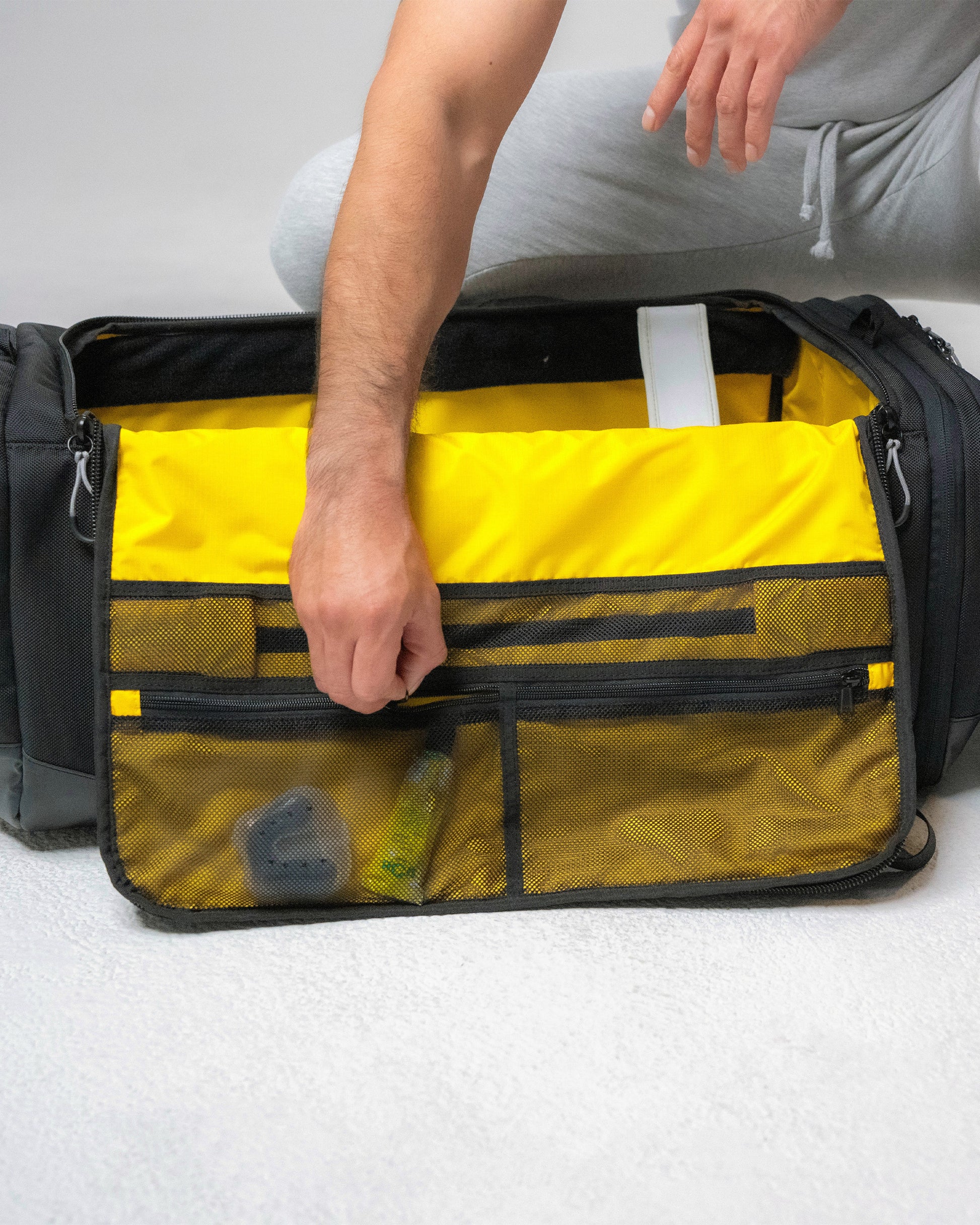 Interior lid panel of the Scuffle Duffle with zippered mesh pockets for small accessories